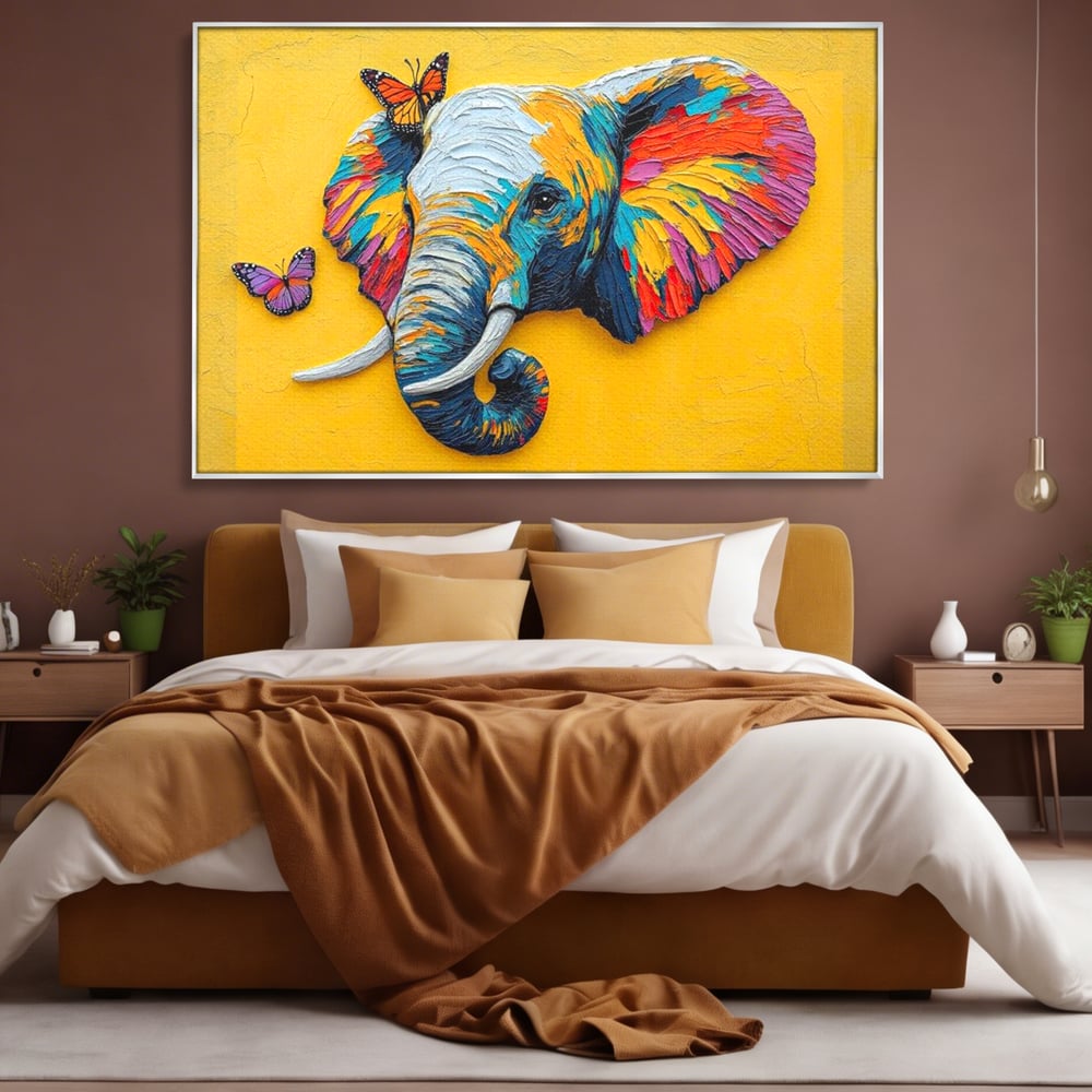 Tablou canvas cu tablou canvas cu elefant colorat si fluturi, in rama de aluminiu argintiu, pe perete intr-un dormitor